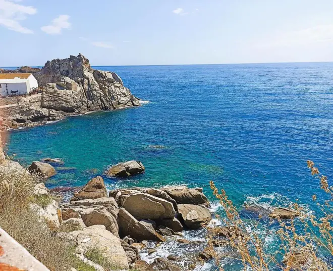 Rocky Costa Brava coastline and turquoise sea at Sant Joan de Palamós